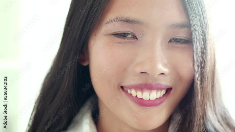 Portrait of a beautiful Asian woman smiling and laughing. Portrait of a beautiful Asian woman smiling and laughing.