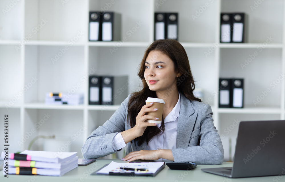 Happy business woman sitting in office desk. Happy business woman sitting in office desk.