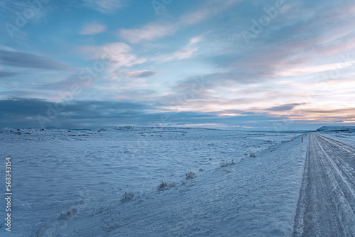 Iceland, Norðurþing, Winter panorama snow road with red orange sunset