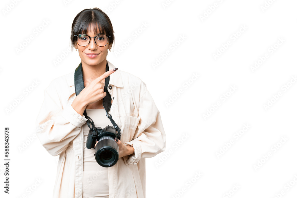 Young photographer caucasian woman over isolated chroma key background pointing to the side to present a product Young photographer caucasian woman over isolated chroma key background pointing to the side to present a product