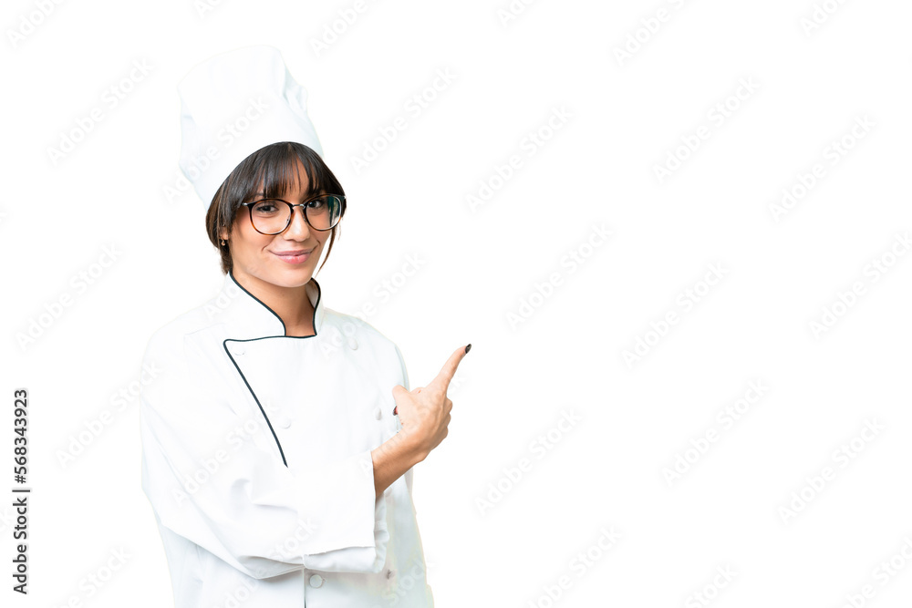 Young caucasian chef woman over isolated chroma key background pointing back Young caucasian chef woman over isolated chroma key background pointing back