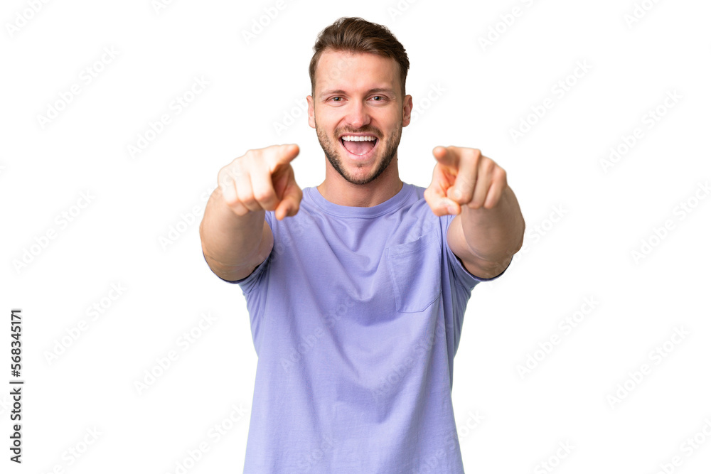 Young handsome caucasian man over isolated chroma key background surprised and pointing front Young handsome caucasian man over isolated chroma key background surprised and pointing front