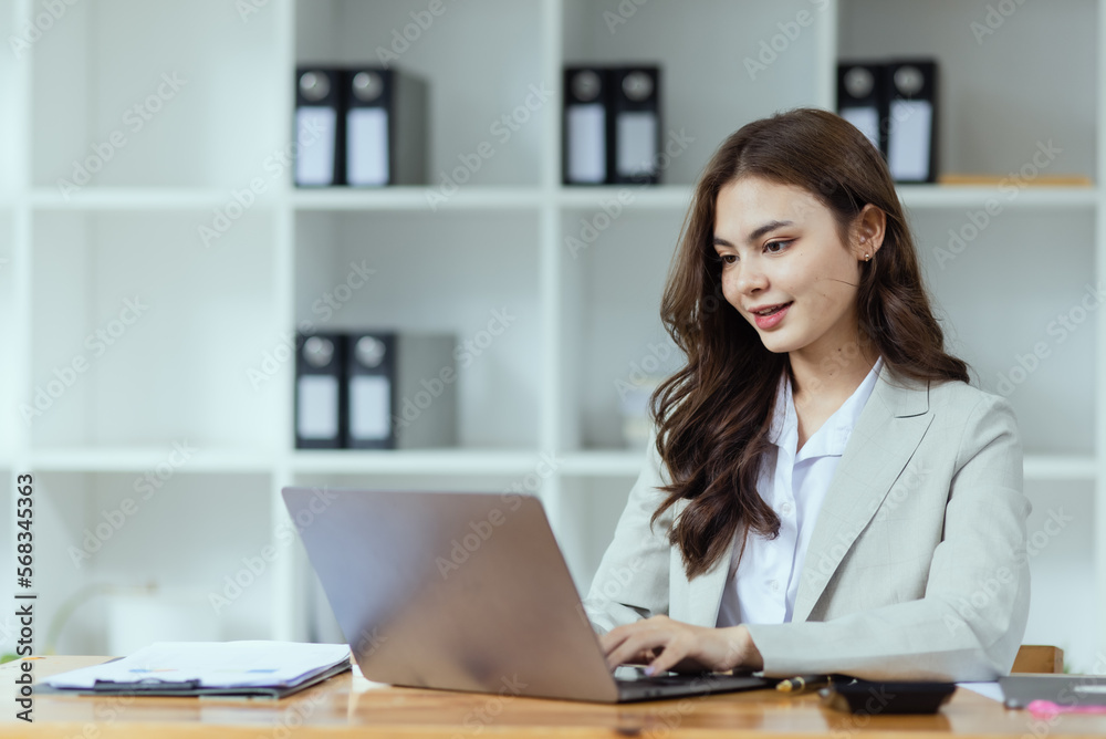 Portrait of young business woman working on laptop, Portrait of young business woman working on laptop,
