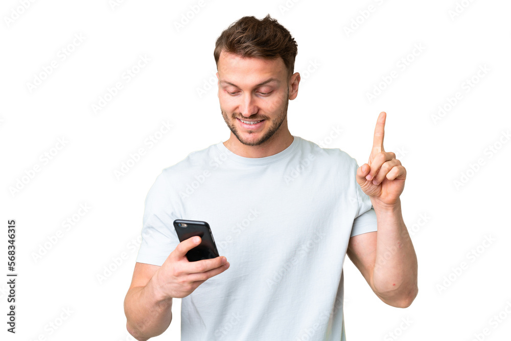 © luismolinero - Young handsome caucasian man over isolated chroma key background using mobile phone and lifting finger © luismolinero - Young handsome caucasian man over isolated chroma key background using mobile phone and lifting finger