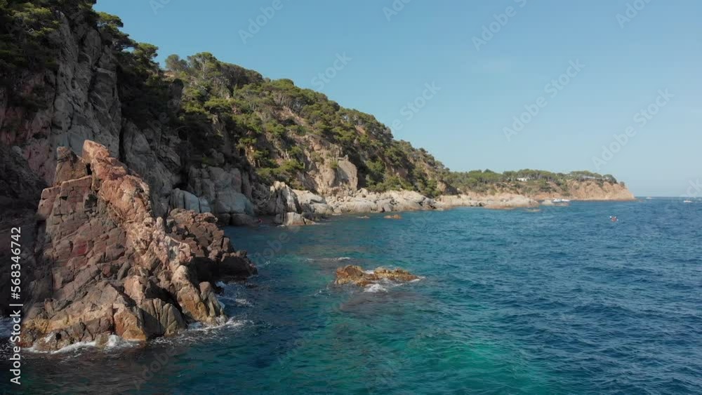 A man kayaking along the coast of Spain in the Mediterranean sea. A man kayaking along the coast of Spain in the Mediterranean sea.