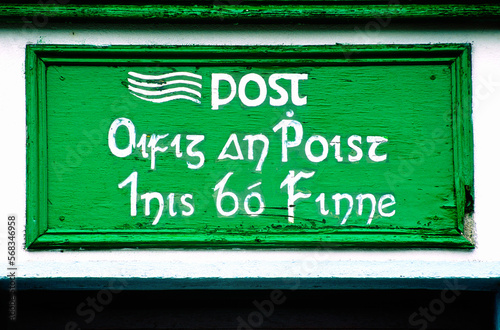 Post office sign in Irish Gaelic language hand painted on island of Inishbofin off the coast of County Galway in western Ireland photo