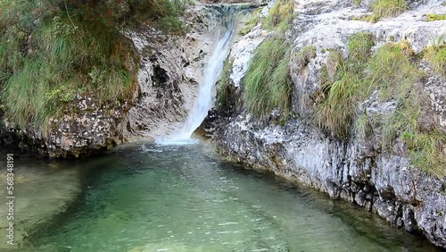 the natural waterfalls on the Brenton lakes in the Belluno Dolomites in Italy photo