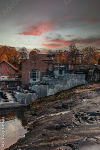 Old abandoned factory in autumn by the river