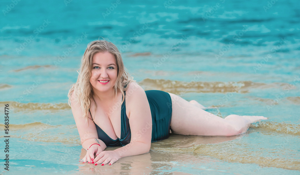 Plus size woman in water in swimsuit. Chubby nice lady, body positive concept, different women sizes