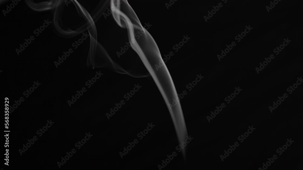 Abstract smoke or steam is rising and floating in the air on a black background. Abstract smoke or steam is rising and floating in the air on a black background.