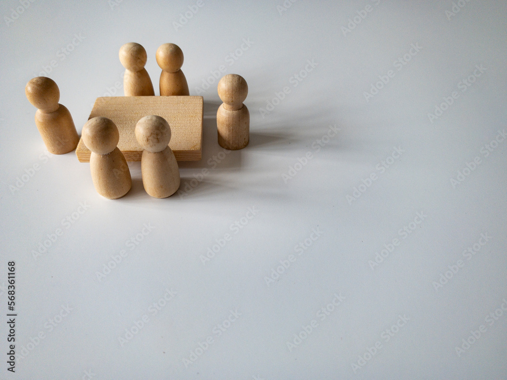 Wooden people figures having business meeting with customizable space for text. Business concept and copy space. Wooden people figures having business meeting with customizable space for text. Business concept and copy space.