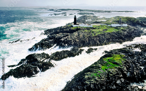 Stormy Atlantic weather. Slyne Head lighthouse marks the treacherous rocks of at southwest tip of Connemara, County Galway, Ireland. Aerial photo