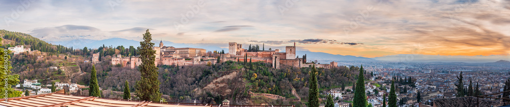 Panoramic of the Alhambra, Palace of Carlos V, Sierra Nevada and the city of Granada, from the viewpoint of San Nicolas at sunset.