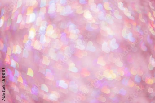 Abstract blurred background with pink pastel colored hearts, color gradient photo, blurred lights as hearts bokeh, romantic holiday, valentine Day festive wallpaper. Glittering aesthetic backdrop