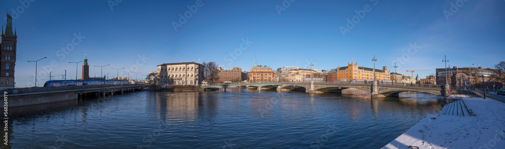 Panorama. The Town City Hall, government and department buildings. The bridge Vasabron and the high way Söderleden passing over the river Strömmen a sunny snowy winter day in Stockholm