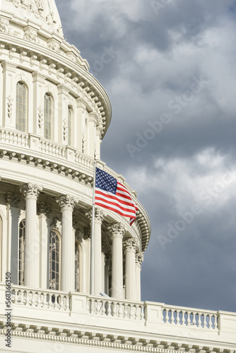 US Capitol dome and national flag in clouds, Washington DC USA 