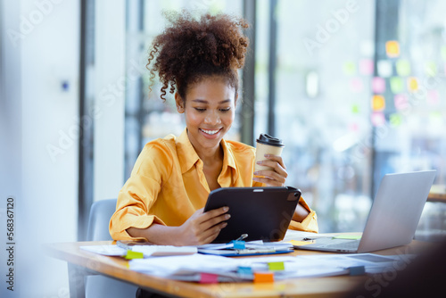 Fotografia Young African American businesswoman working with pile of documents at office workplace, business finance and accounting concepts