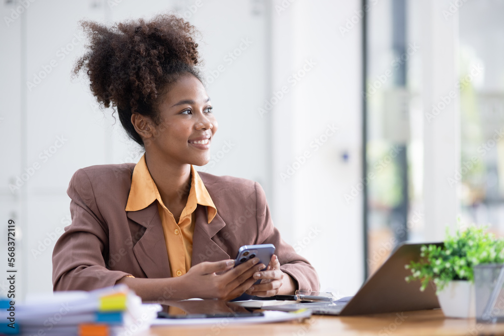 Young African American businesswoman working with pile of documents at office workplace, business finance and accounting concepts. Young African American businesswoman working with pile of documents at office workplace, business finance and accounting concepts.