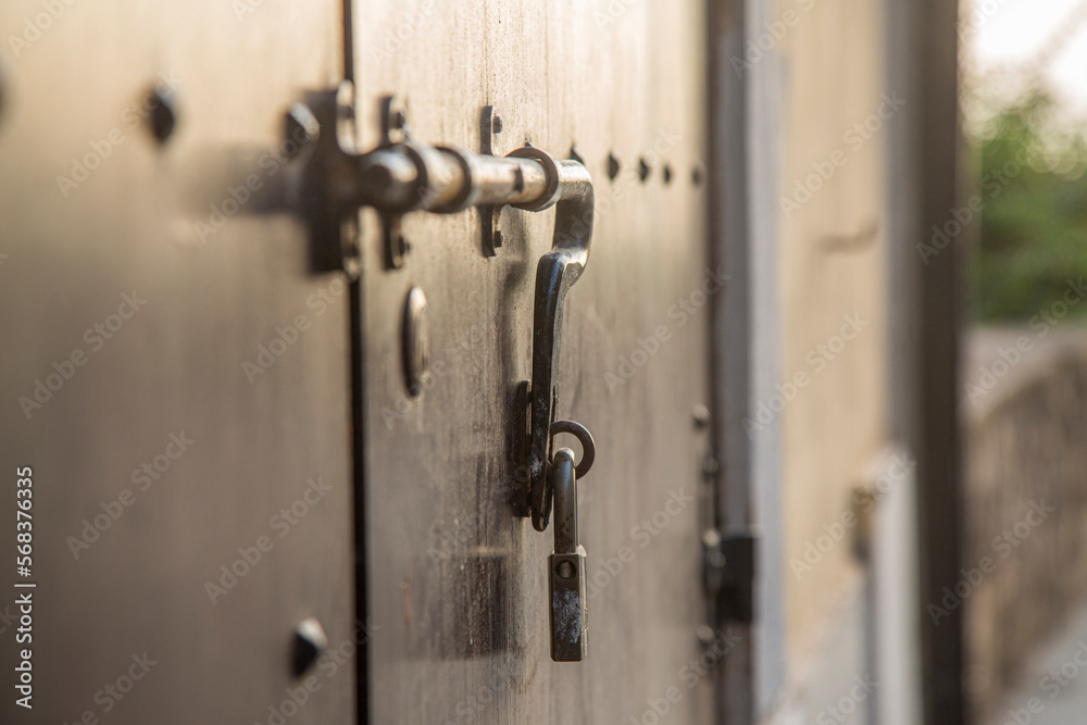 Fototapeta premium Old wooden doors with rings and old-fashioned vintage steel knocker handle close up in Italy.