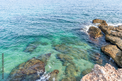 cliff overlooking the sea with turquoise waters where you can see the seabed