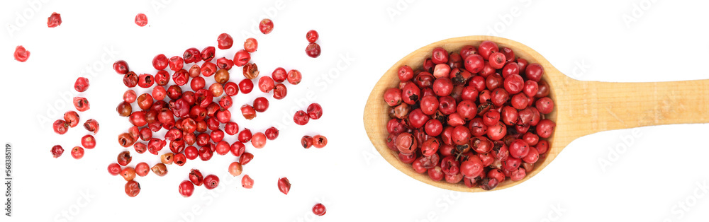 red peppercorns seeds in wooden spoon isolated on white background. Top view. Flat lay red peppercorns seeds in wooden spoon isolated on white background. Top view. Flat lay
