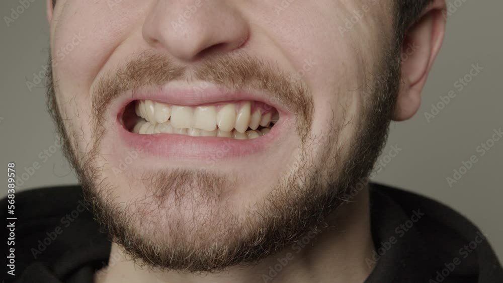 A young man with a beard who smiles widely and shows all his teeth. Young man showing all his teeth slowly to the camera. Content for dentists and orthodontic and dental treatment. A young man with a beard who smiles widely and shows all his teeth. Young man showing all his teeth slowly to the camera. Content for dentists and orthodontic and dental treatment.