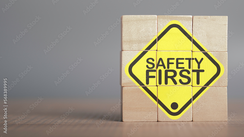 Work safety concept. Safety first text yellow in wooden cube and copy spec. Safety first sign on virtual screen. Hazards, protections, regulations and insurance, Zero accidents, Protection dangerous. - obrazy, fototapety, plakaty 