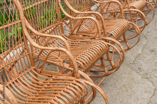 rocking chairs standing made with withe staning on rough surface in Ukrainain village photo