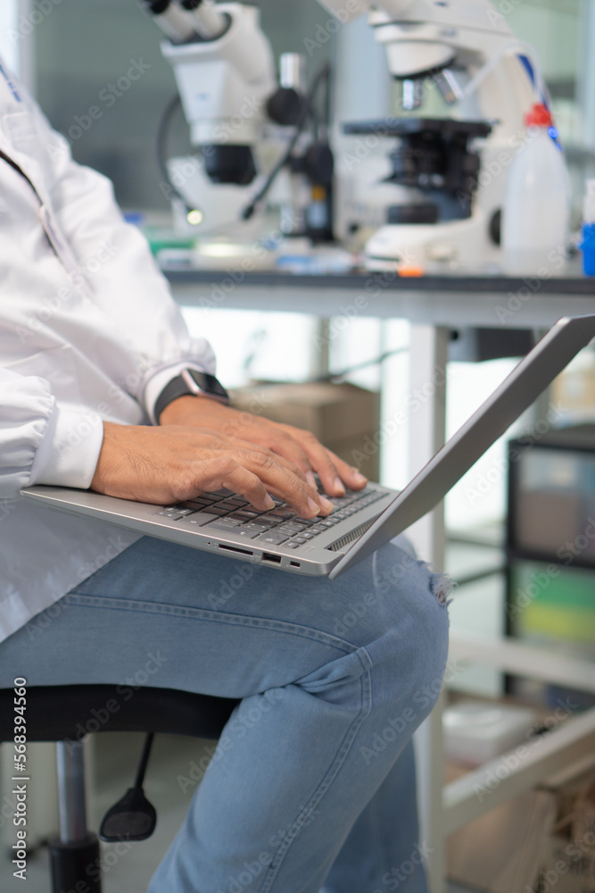 Close-up of a scientist using a laptop computer in the laboratory