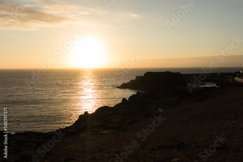 backlit seascape, beautiful golden sunset over the sea from the cliffs. El Cotillo, Fuerteventura, Canary Islands, Spain