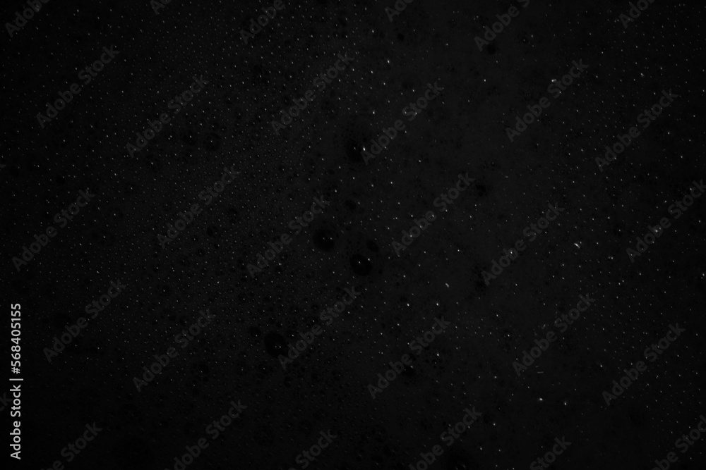 Black abstract background texture with bubbles.