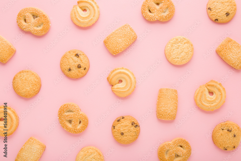 Different dry butter cookies on light pink table background. Pastel color. Closeup. Sweet snacks. Biscuit pattern. Top down view. Different dry butter cookies on light pink table background. Pastel color. Closeup. Sweet snacks. Biscuit pattern. Top down view.