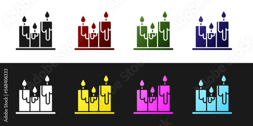 Set Burning candles icon isolated on black and white background. Cylindrical candle stick with burning flame. Vector Illustration