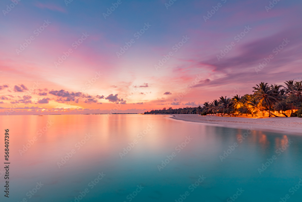 Beautiful panoramic sunset tropical paradise beach. Tranquil summer vacation or holiday landscape. Exotic sunrise beach seaside palm trees silhouette sea bay view inspirational seascape and sky clouds