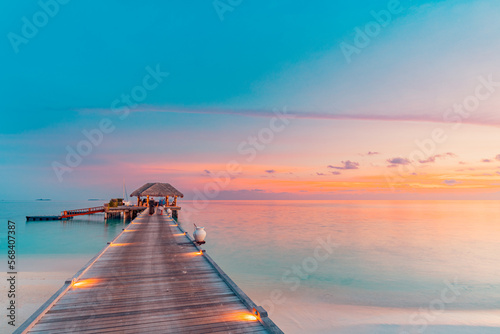 Amazing beach landscape. Beautiful Maldives sunset seascape view. Horizon colorful sea sky clouds, over water villa pier pathway. Tranquil island lagoon, tourism travel background. Exotic vacation 