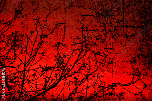Textured old paper background with spring tree young branches against red sunset sky. Things differing strikingly. Rough radically contrasting background photo