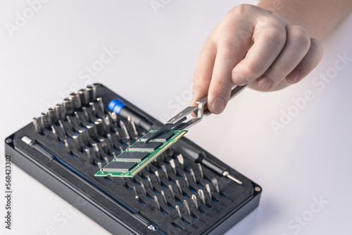 Technician fixing computer. Repair and upgrade concept of laptop. Workshop background