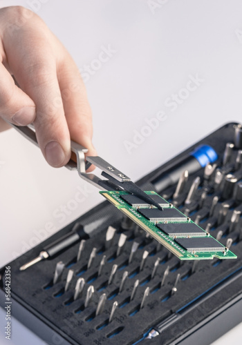 Technician fixing computer. Repair and upgrade concept of laptop. Workshop background