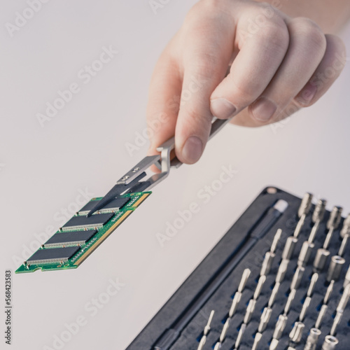 Technician fixing computer. Repair and upgrade concept of laptop. Workshop background