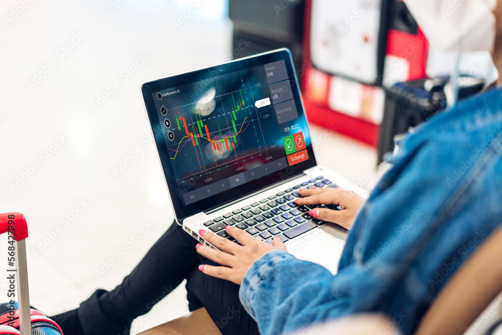 Fototapeta premium Successful of business trader investor woman use technology laptop trading graph of block chain stock market cryptocurrency investment selling and buy with price chart data graph
