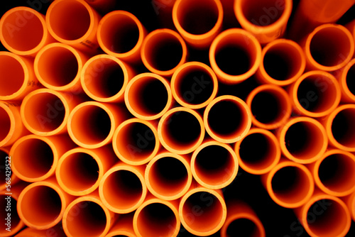 Background of the orange plastic pipes in stacked