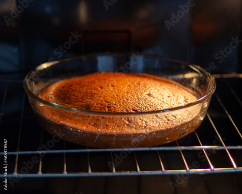 Hot ruddy cake in a home oven. Cooked pie in a glass pan. Homemade baking. Delicious food and dessert. Healthy eating