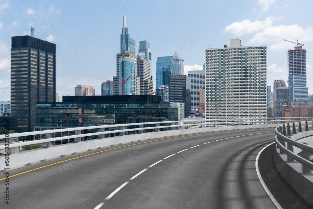 Fototapeta premium Empty urban asphalt road exterior with city buildings background. New modern highway concrete construction. Concept way to success. Transportation logistic industry fast delivery. Philadelphia. USA.