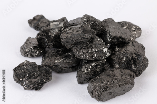 Heap of natural black fossil coal on a white isolated background.