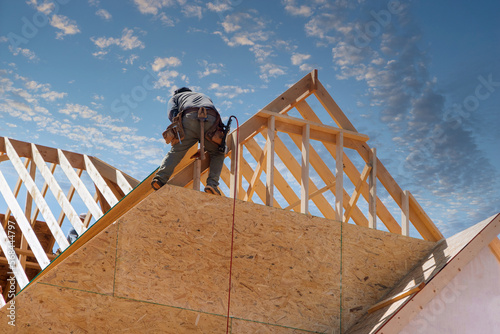 Build wooden roof rafters timber beams from framework of truss frames construction stick for house under construction