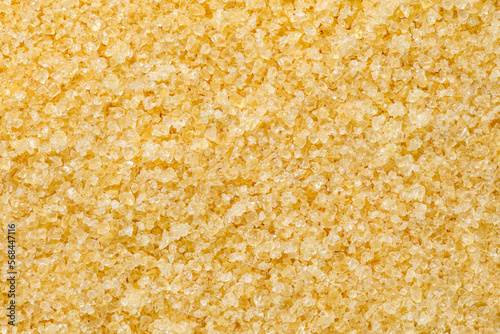 Gelatin, yellow granules, small crystals, background uniform texture, in bulk close-up top view