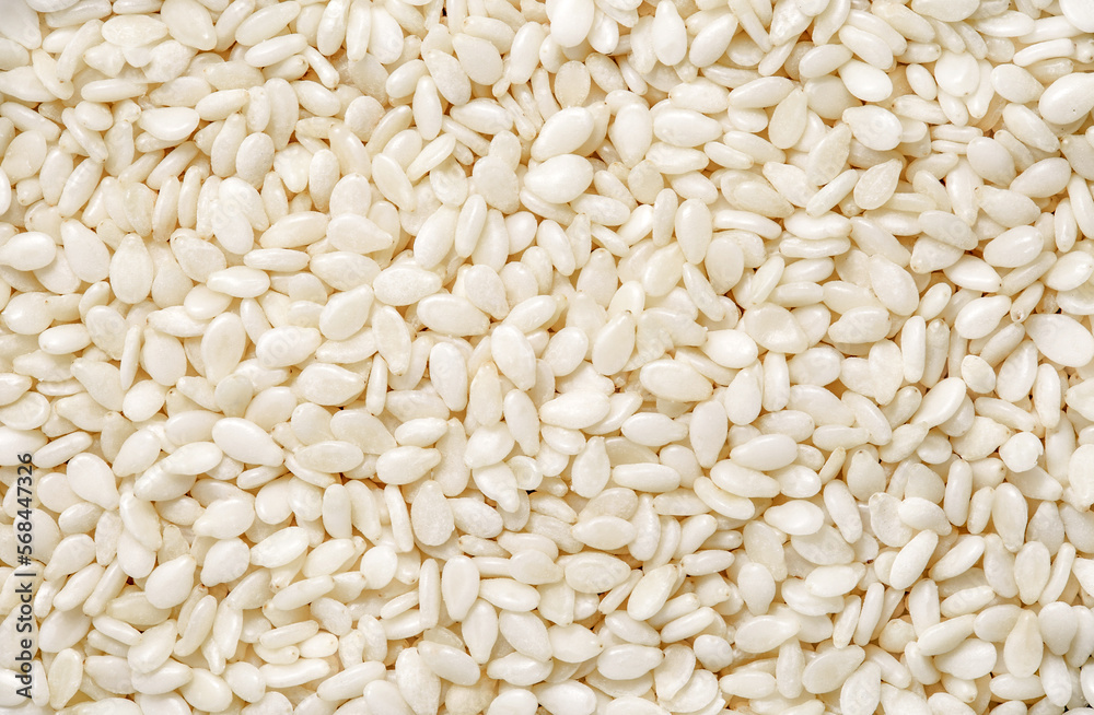 Sesame seeds, small grains, background uniform texture, in bulk, close-up Sesame seeds, small grains, background uniform texture, in bulk, close-up