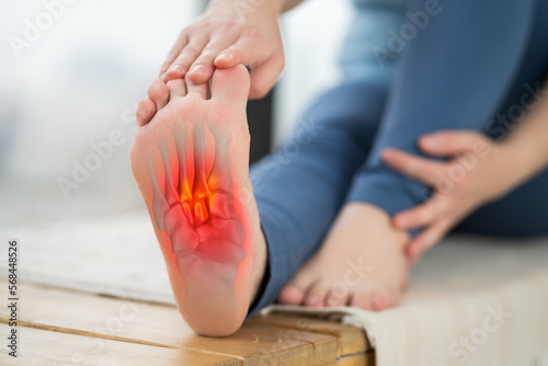 Joint diseases, hallux valgus, plantar fasciitis, heel spur, woman's leg hurts, pain in the foot, massage of female feet at home photo