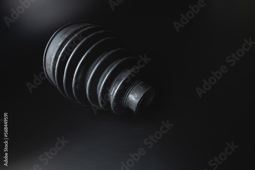 Close-up of a rubber boot on a CV joint on a black background in selective focus