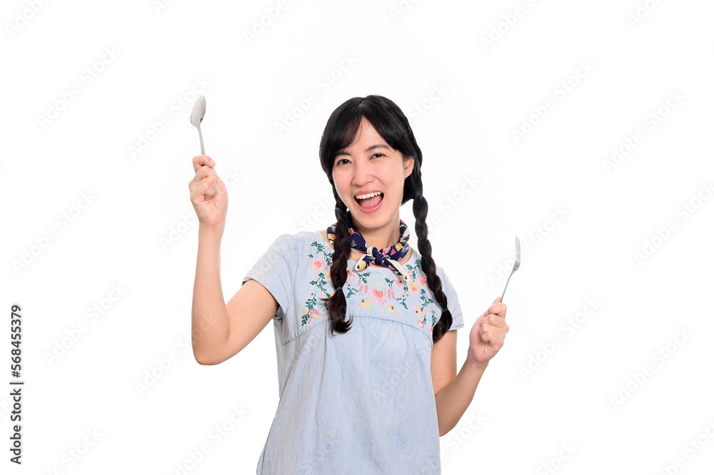 Portrait of beautiful young asian woman smile in denim dress with spoon and fork on white background Portrait of beautiful young asian woman smile in denim dress with spoon and fork on white background